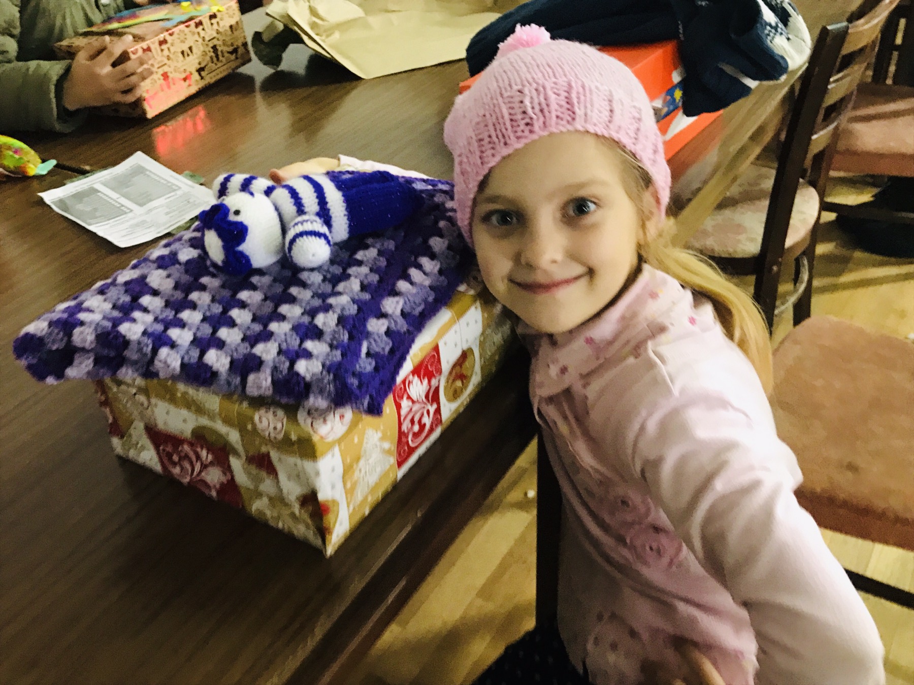 A young child receiving a shoebox courtesy of Link to Hope's Shoebox Appeal