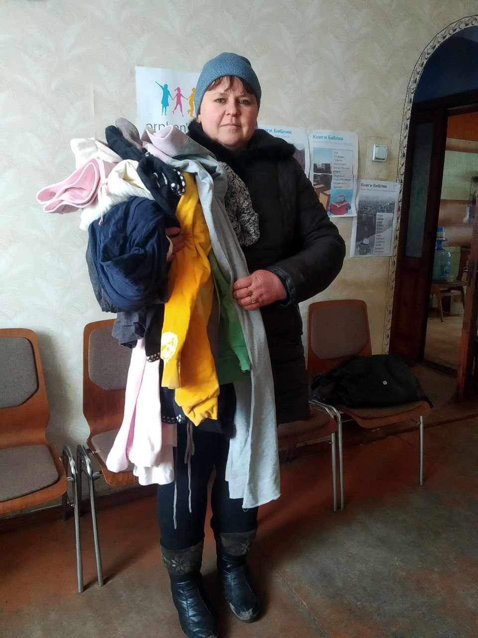 Angel of Light - Ukraine, Woman with donated clothes