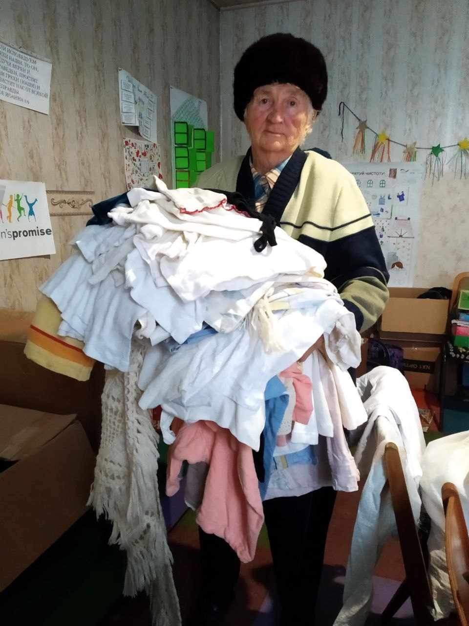 Angel of Light Project, Ukraine- Man holding donated clothes